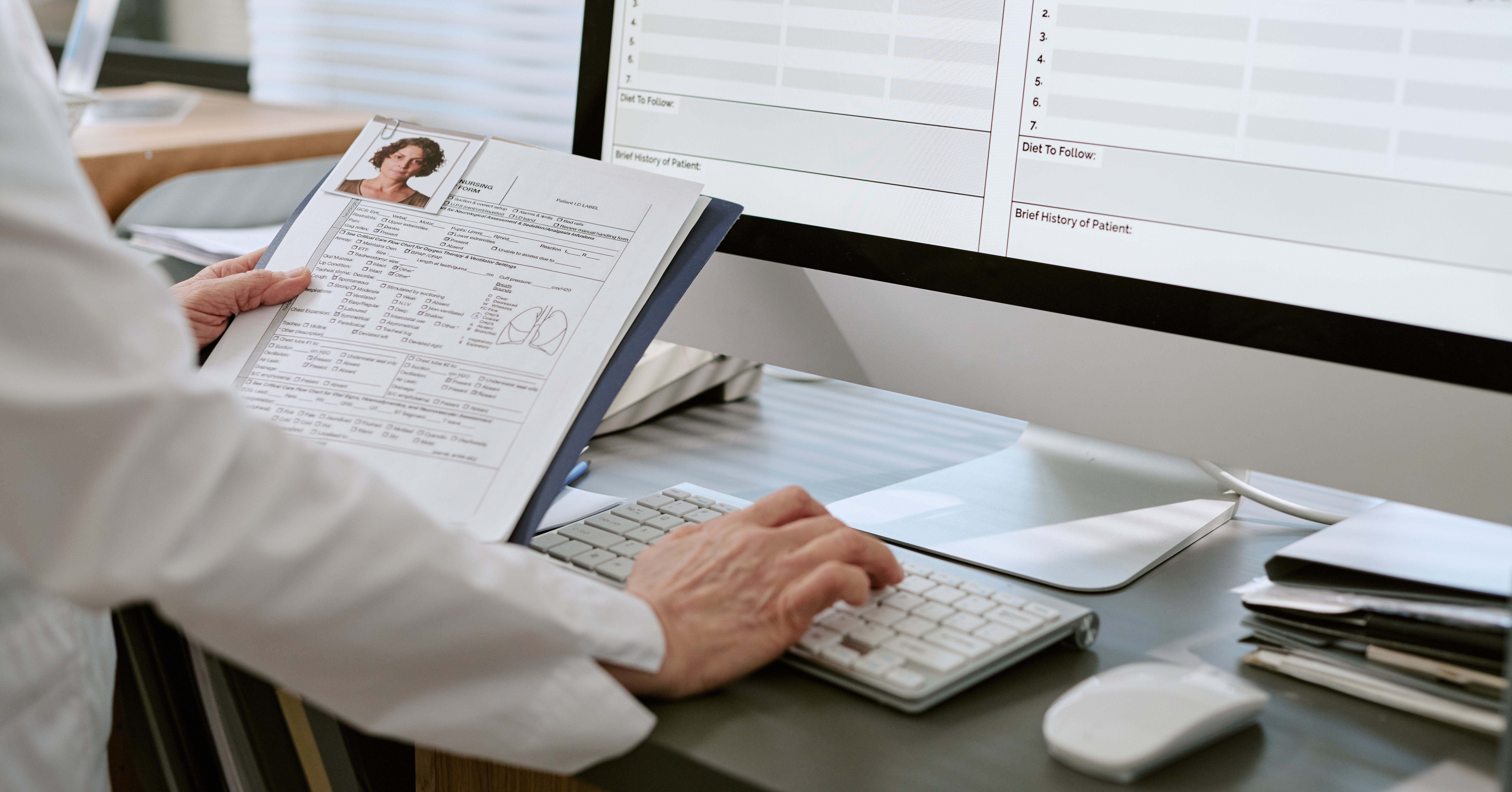 Healthcare professional reviewing patient records and clinical documentation using electronic health record software