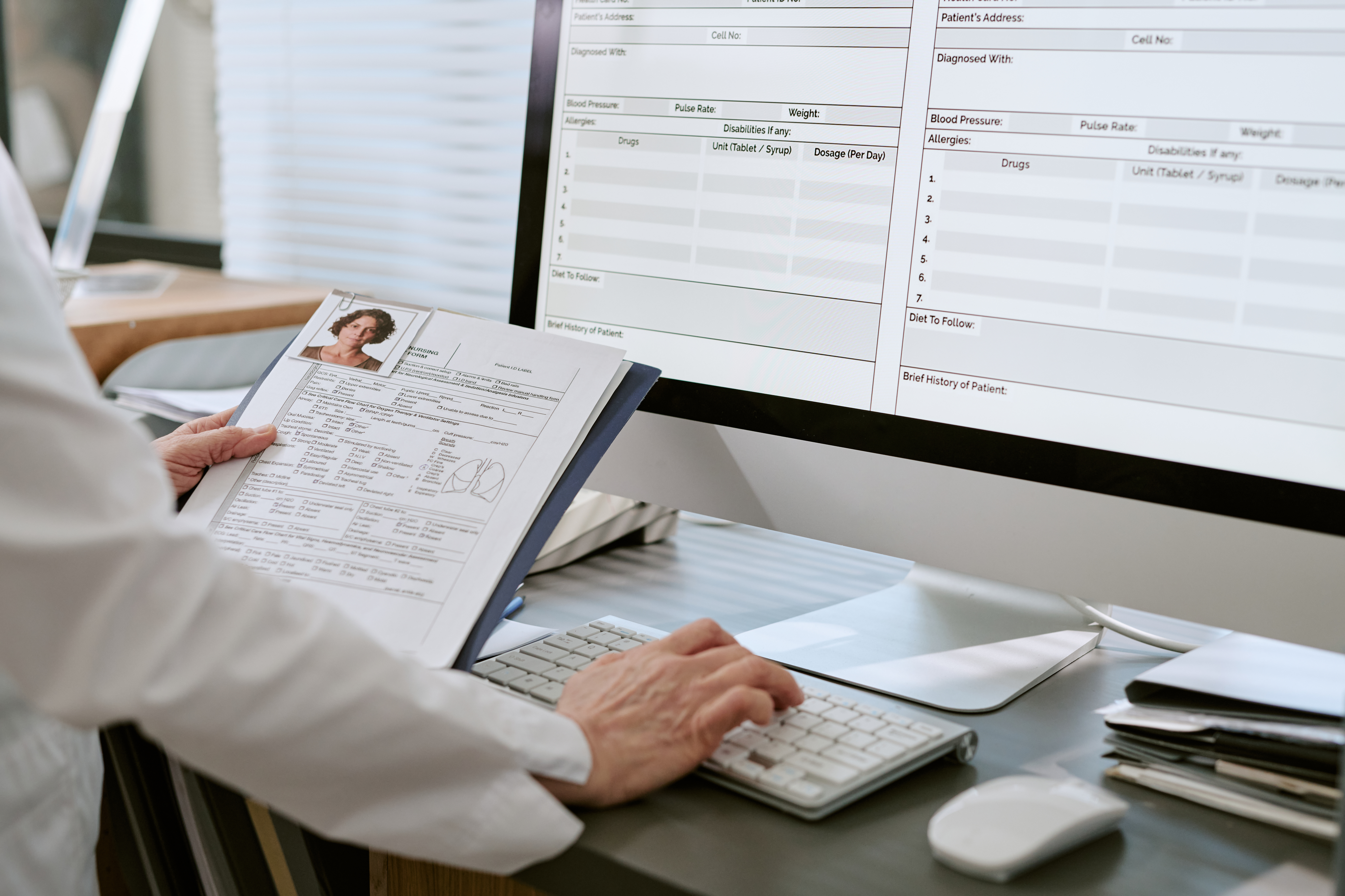 Healthcare professional reviewing patient records and clinical documentation using electronic health record software